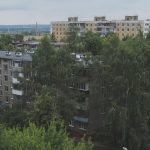 green trees near brown concrete building during daytime